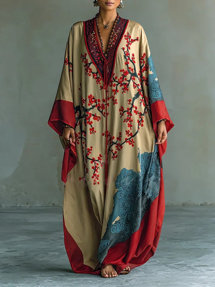 Beige silk maxi dress with V-neck trim, red floral vines, blue patterned hem, draped