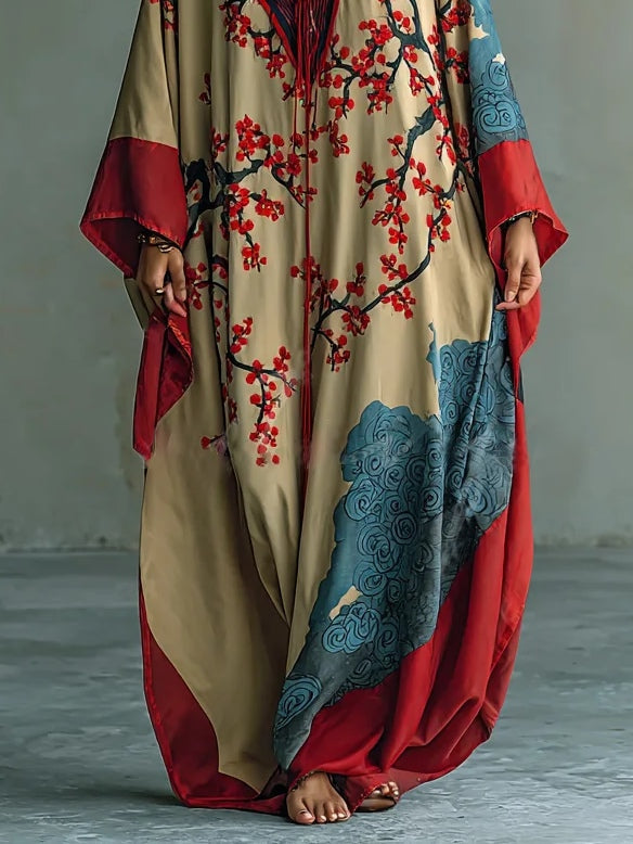 Beige silk maxi dress with red floral print, blue bottom panel, red side borders, draped