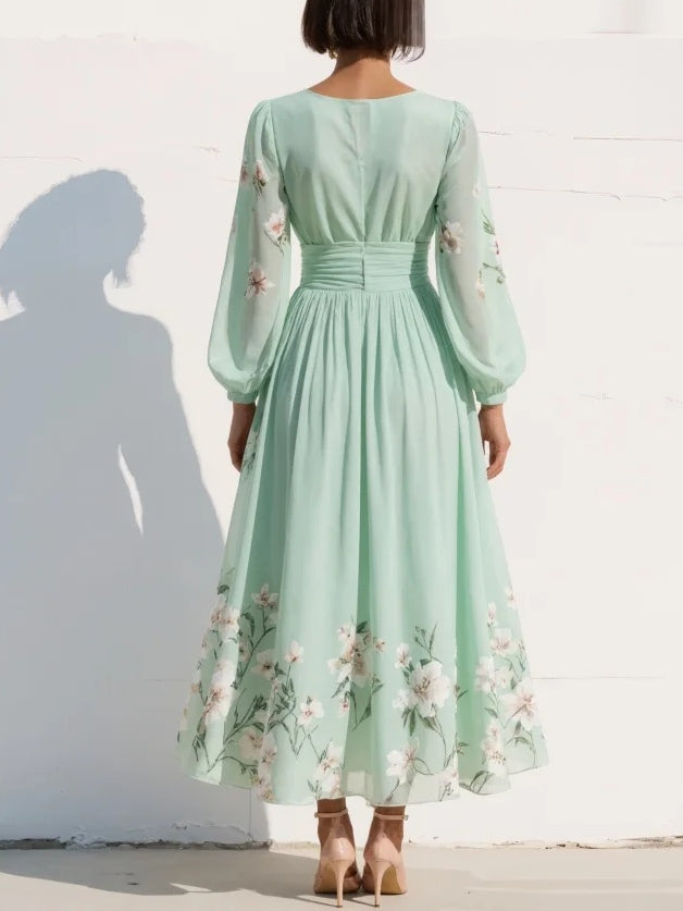 Back view of mint green floral midi dress with long sheer sleeves and gathered waist