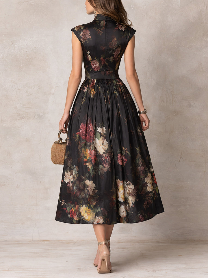 Back view of sleeveless midi dress with dark floral print and pleated skirt