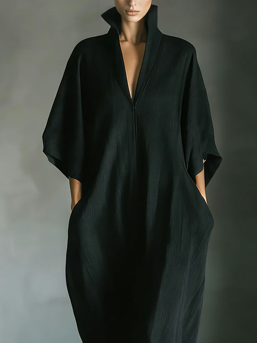 Black V-neck maxi dress close-up with draped collar and loose dolman sleeves