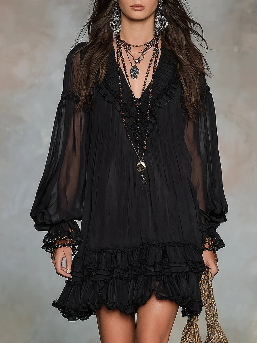 Black mini dress with sheer puff sleeves and tiered ruffle hem