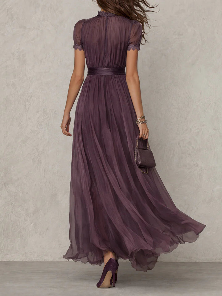 Lace-detail maxi dress in dark plum, cinched waist, short puff sleeves, layered flowing skirt