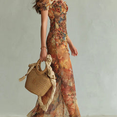 Orange bohemian chiffon maxi dress, side view with short puff sleeves and thigh slit
