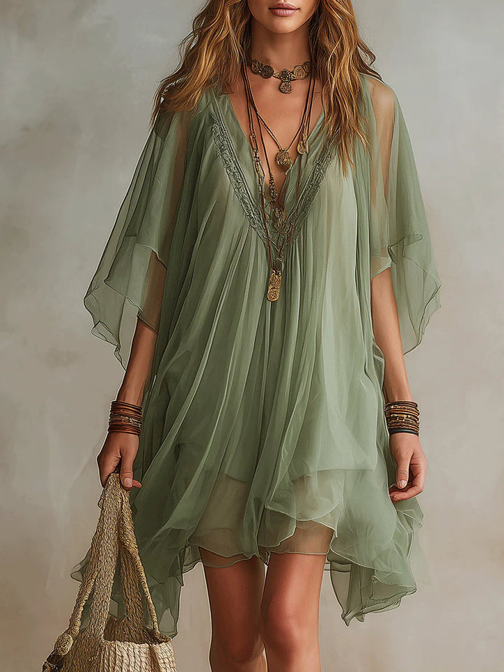 Olive mini dress with V-neck detail, relaxed flutter sleeves, layered hem