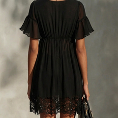 Black lace-trim mini dress back view with short flutter sleeves and gathered waist