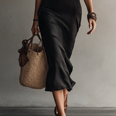 Dark midi dress with draped skirt and lace-trim V front, close view of hem