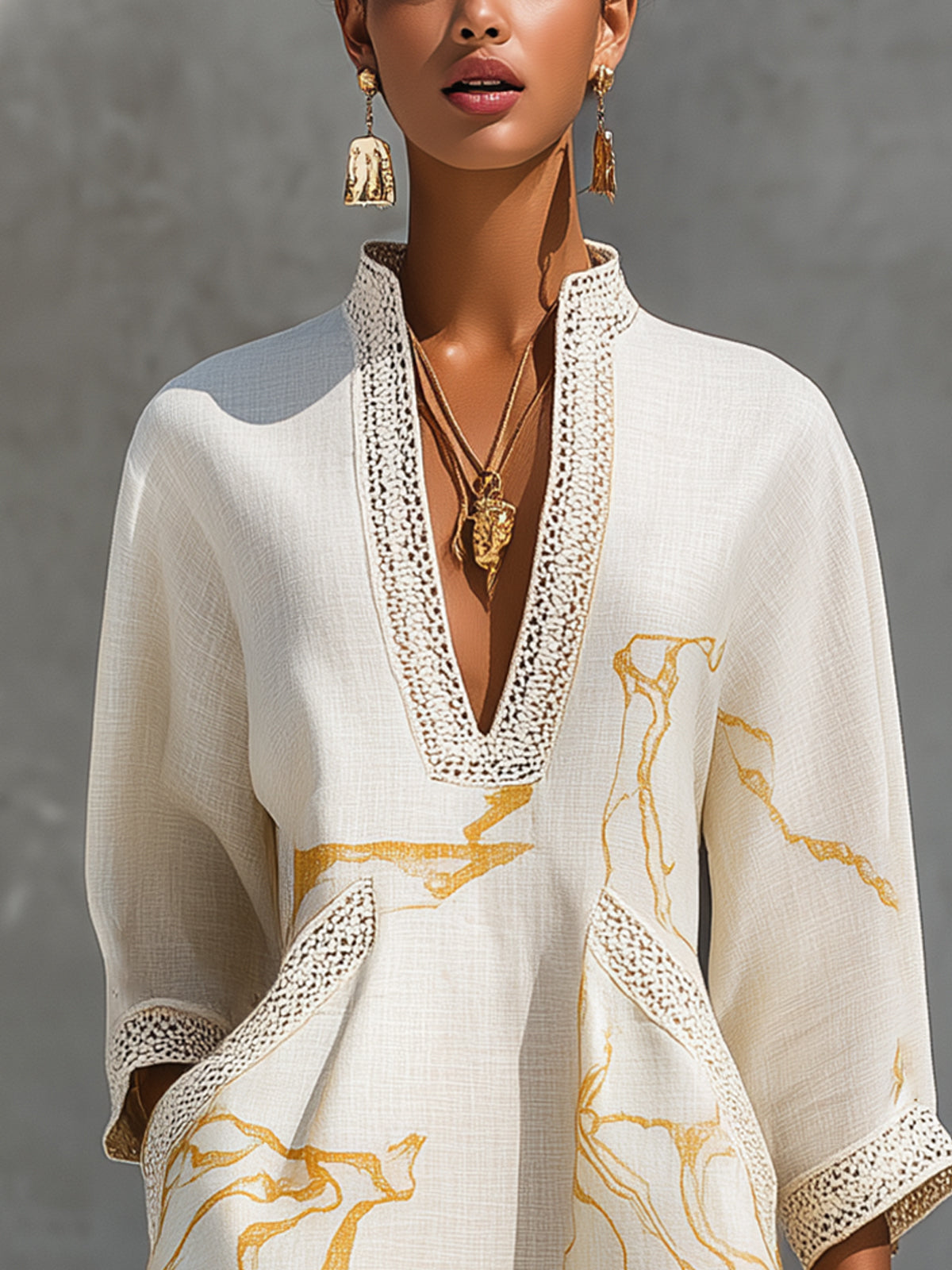 Ivory mini dress close-up: V-neck crochet lace border and gold abstract motif print