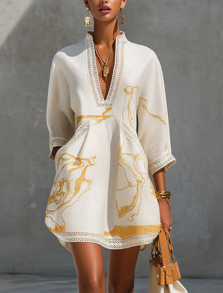 Ivory mini dress with V-neck crochet lace trim and gold abstract print, long sleeves