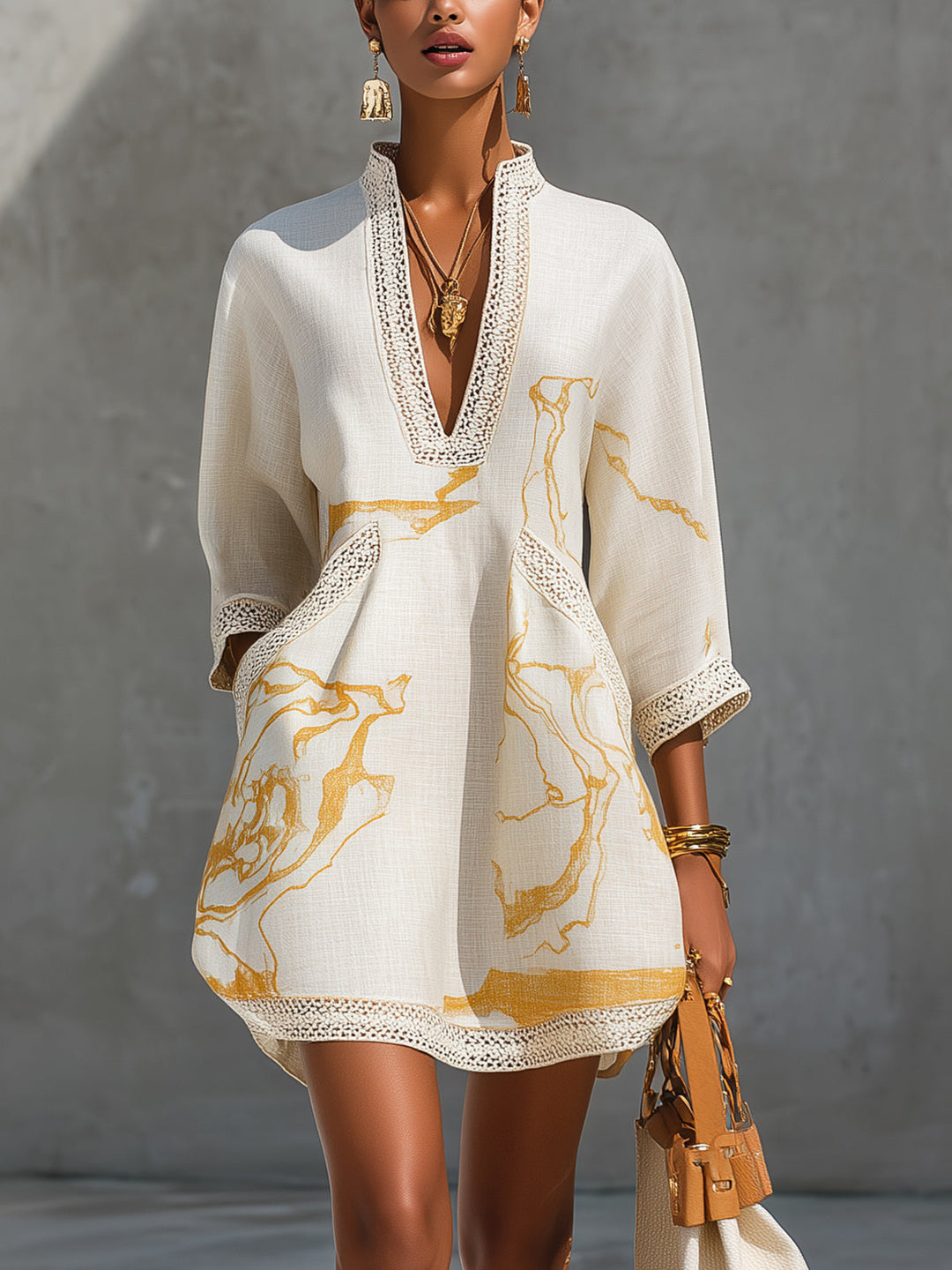 Ivory mini dress with V-neck crochet lace trim and gold abstract print, long sleeves