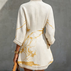 Ivory mini dress, back view: long sleeves, crochet lace hem and gold abstract print