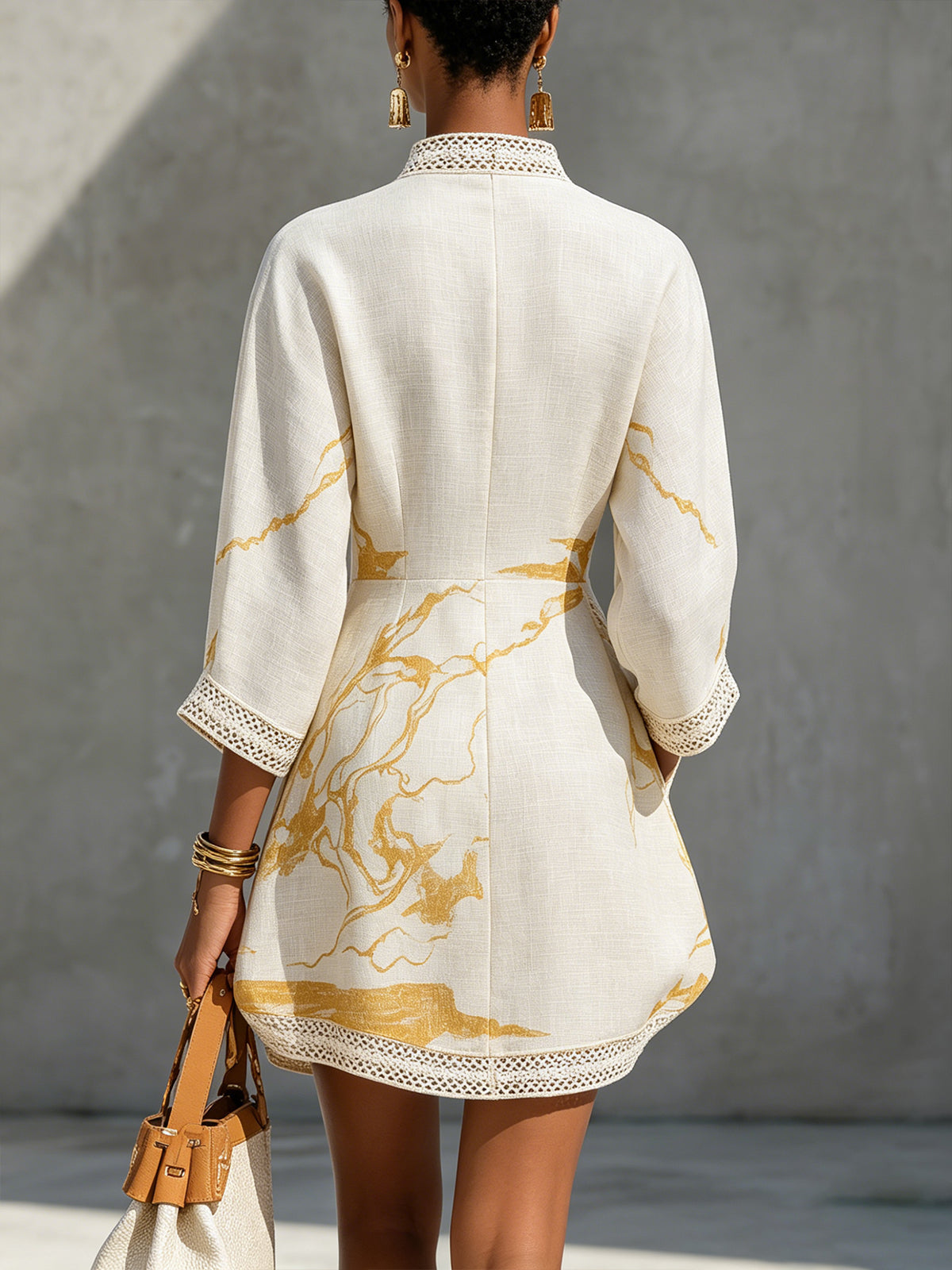 Ivory mini dress, back view: long sleeves, crochet lace hem and gold abstract print
