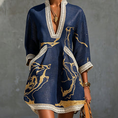 Navy mini dress with V-neck crochet lace trim and gold abstract print, long sleeves
