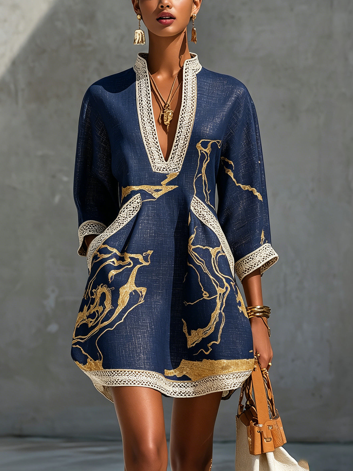 Navy mini dress with V-neck crochet lace trim and gold abstract print, long sleeves