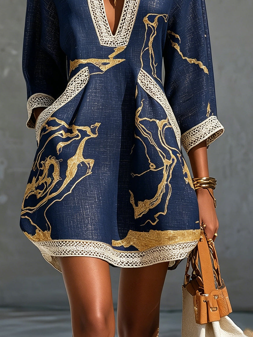 Aurelia crochet lace mini dress in navy with gold swirling print and lace border hem.