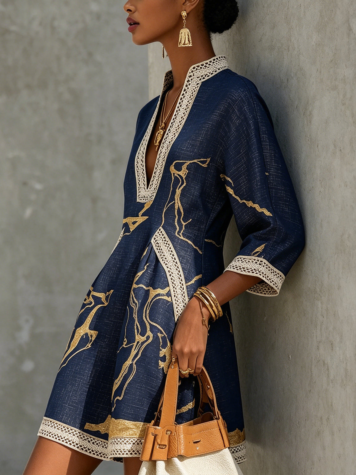 Aurelia crochet lace mini dress in navy with gold motif, V-neck and lace trim.