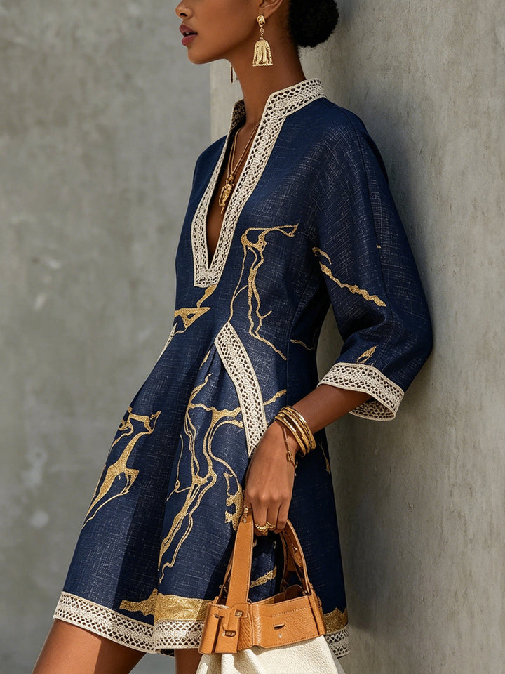 Aurelia crochet lace mini dress in navy with gold motif, V-neck and lace trim.