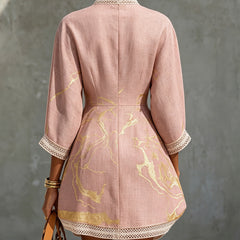 Aurelia crochet lace mini dress in pink, back view with gold motifs and lace-trimmed sleeves.