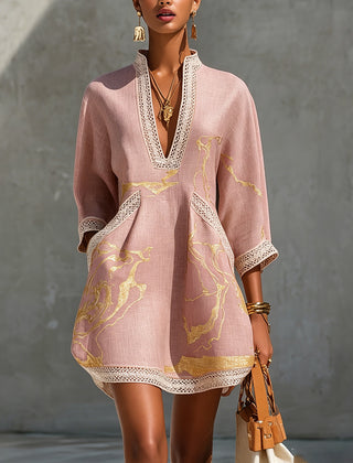 Aurelia crochet lace mini dress in pink with gold pattern, deep V-neck and lace trim.