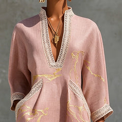 Aurelia crochet lace mini dress in pink with gold V detail and lace trim on neckline.