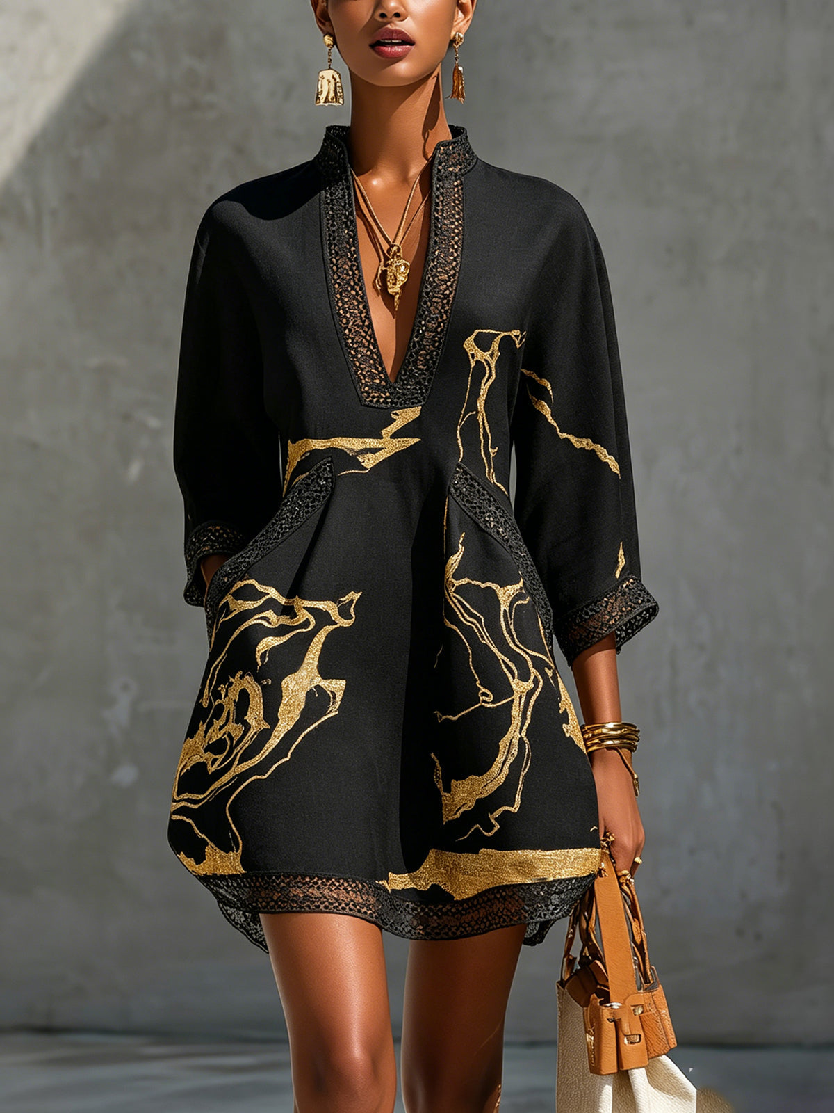 Black mini dress with V-neck crochet lace trim and gold abstract print, long sleeves
