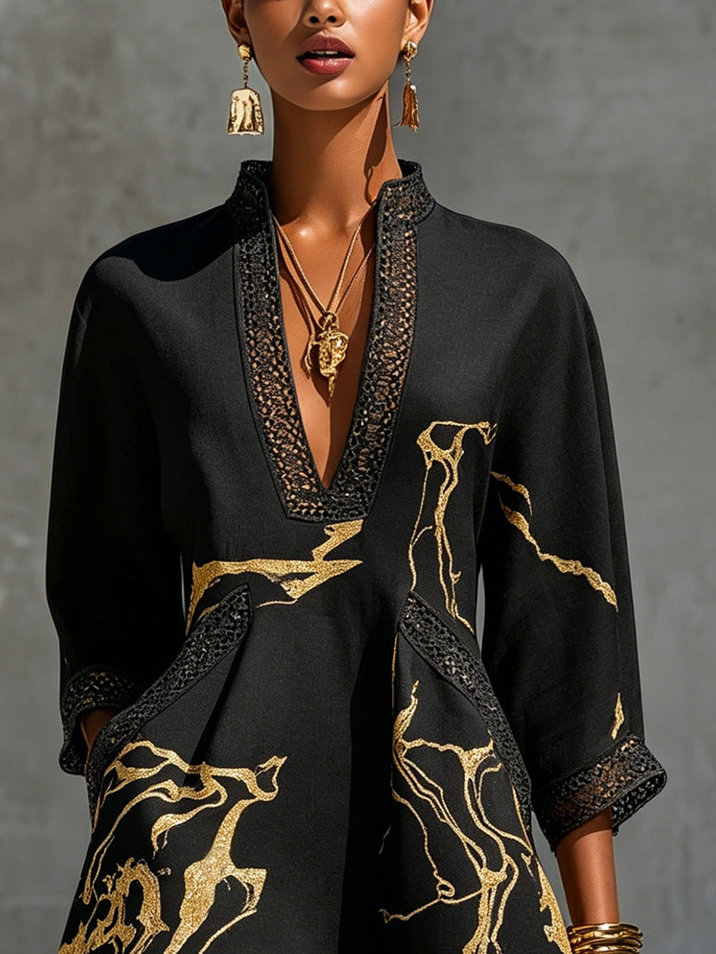 Black mini dress close-up: V-neck crochet lace trim with gold abstract motif print