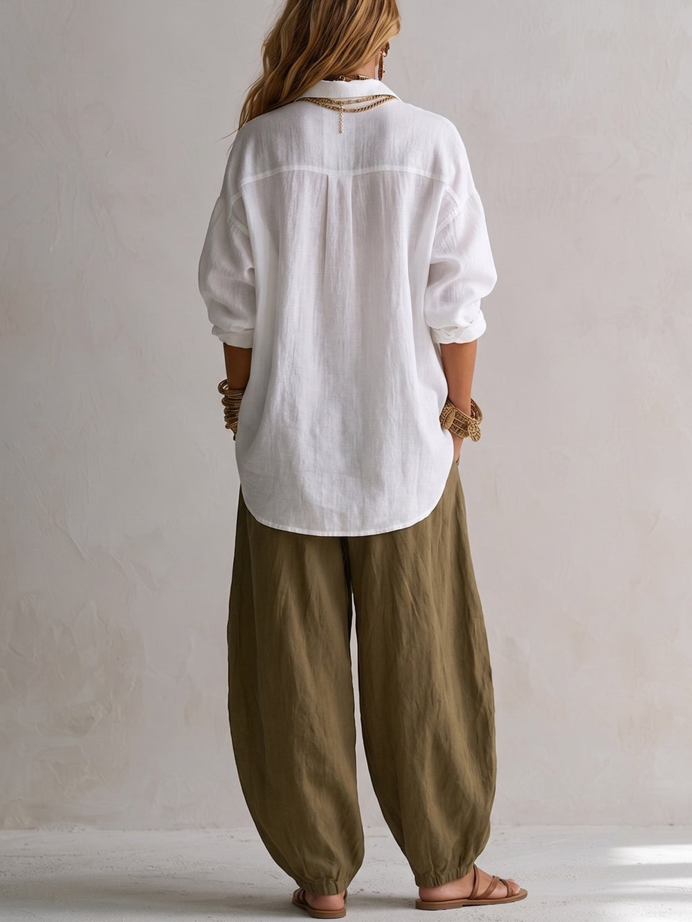 Two-piece linen set: back view white button-up blouse with gold buttons, olive relaxed pants