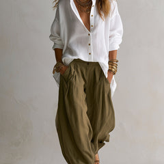 Two-piece linen set: white button-up blouse with gold buttons and olive relaxed pants