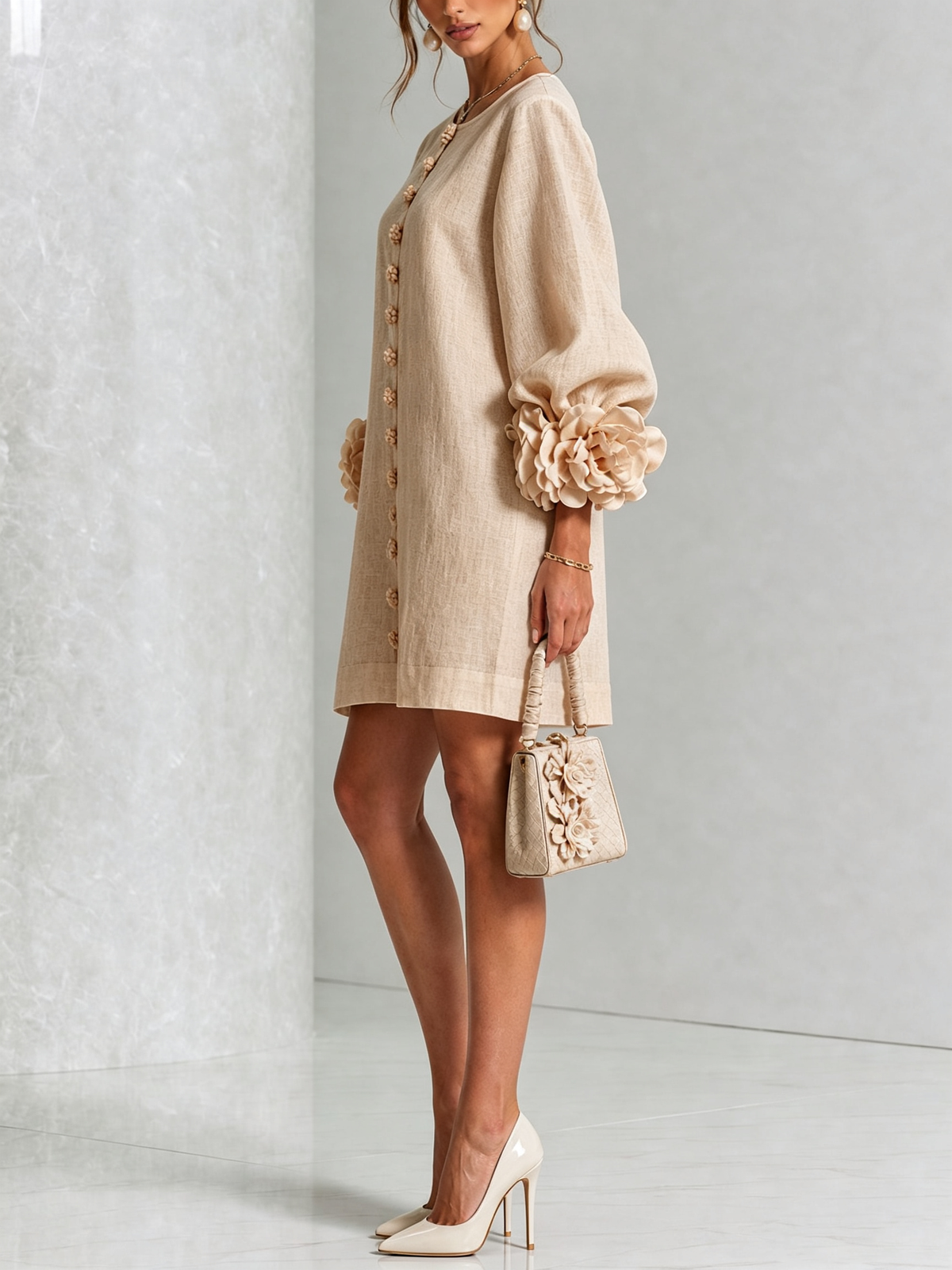 Tan button-down mini dress with long sleeves and large rosette cuff accents