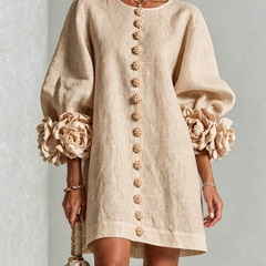 Beige button-down mini dress with long sleeves, embroidered button front, and rosette cuffs