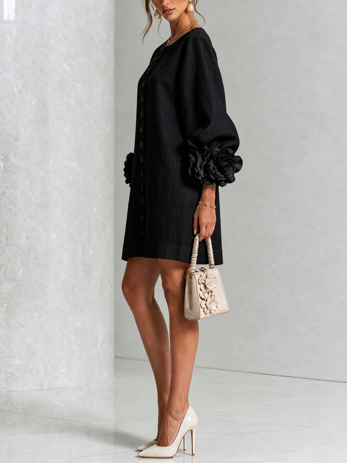 Black button-down mini dress with rosette puff sleeves and front button detail