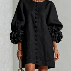 Black button-down mini dress with vertical button placket and large rosette sleeves