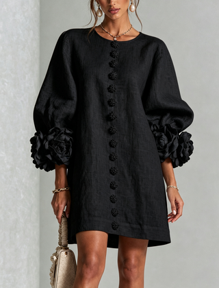 Black button-down mini dress with vertical button placket and large rosette sleeves