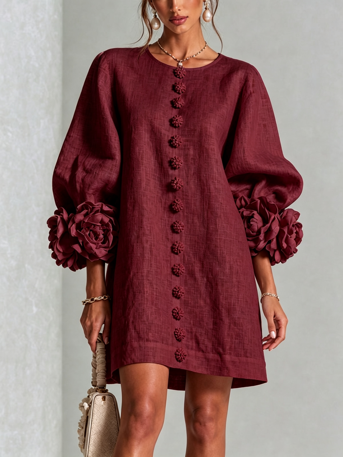 Burgundy button-down mini dress with vertical button placket and rose-like sleeve detailing