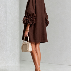 Deep brown button-down mini dress with long sleeves and large rosette cuff detail