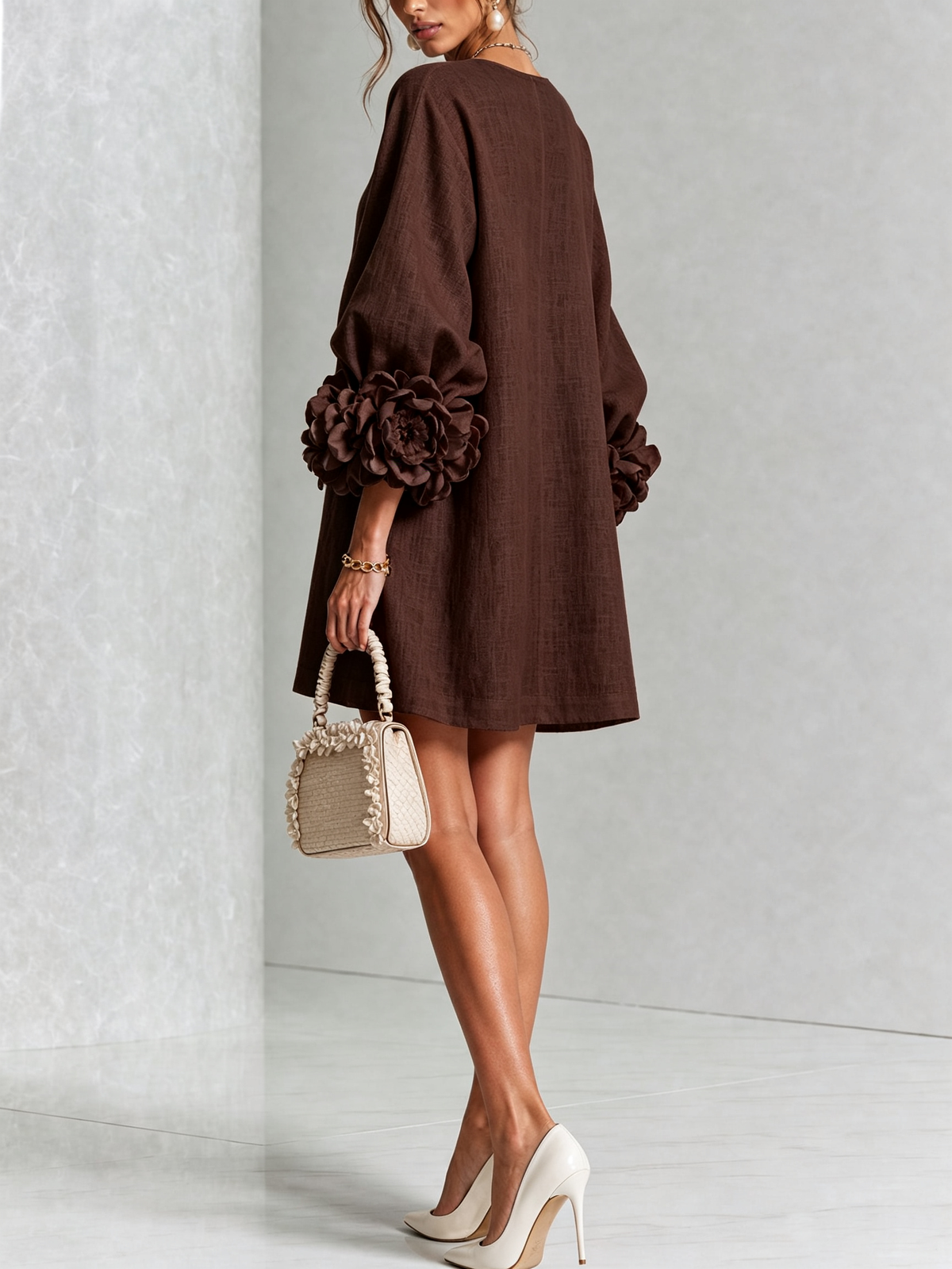 Deep brown button-down mini dress with long sleeves and large rosette cuff detail