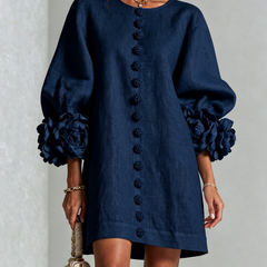 Navy button-down mini dress with vertical button placket and rosette cuff sleeves