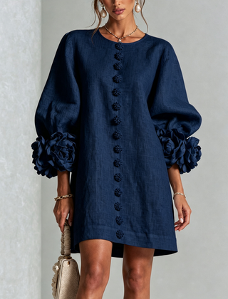 Navy button-down mini dress with vertical button placket and rosette cuff sleeves