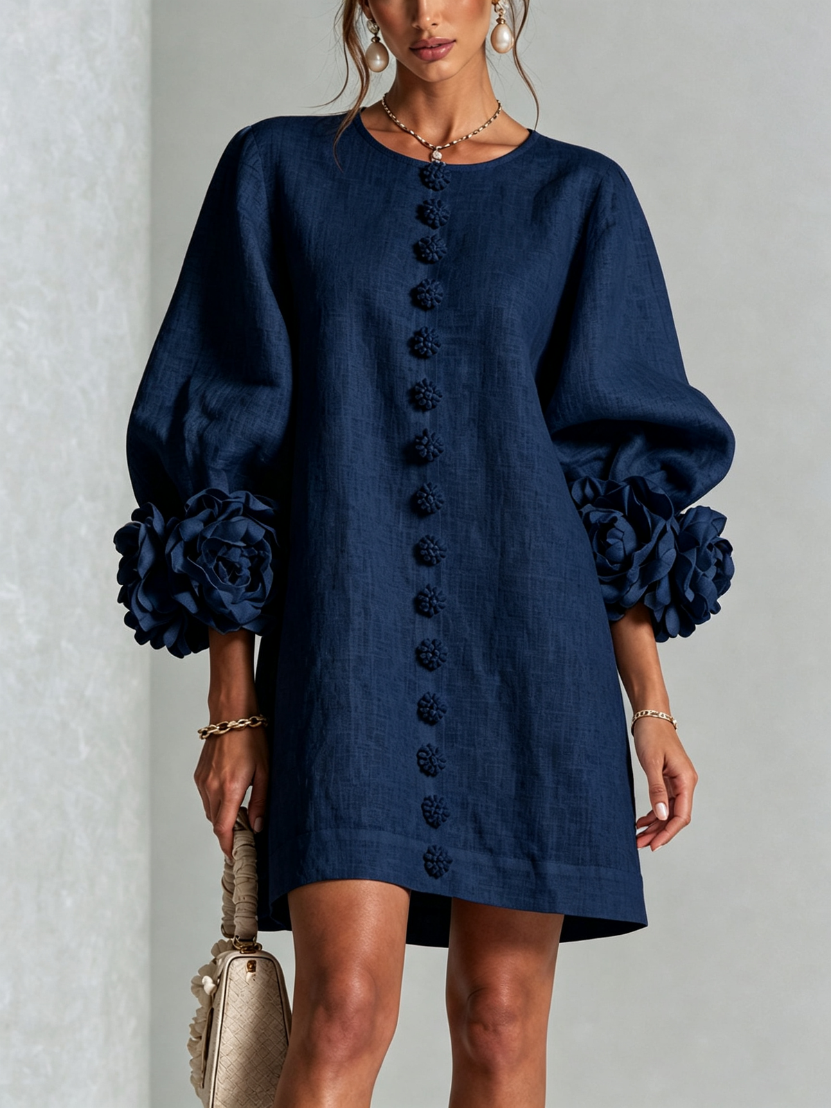 Navy button-down mini dress with vertical button placket and rosette cuff sleeves