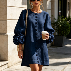 Navy button-down mini dress with vertical buttons and rosette cuff puff sleeves
