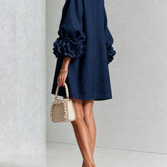 Navy button-down mini dress with rosette puff sleeves and front button placket