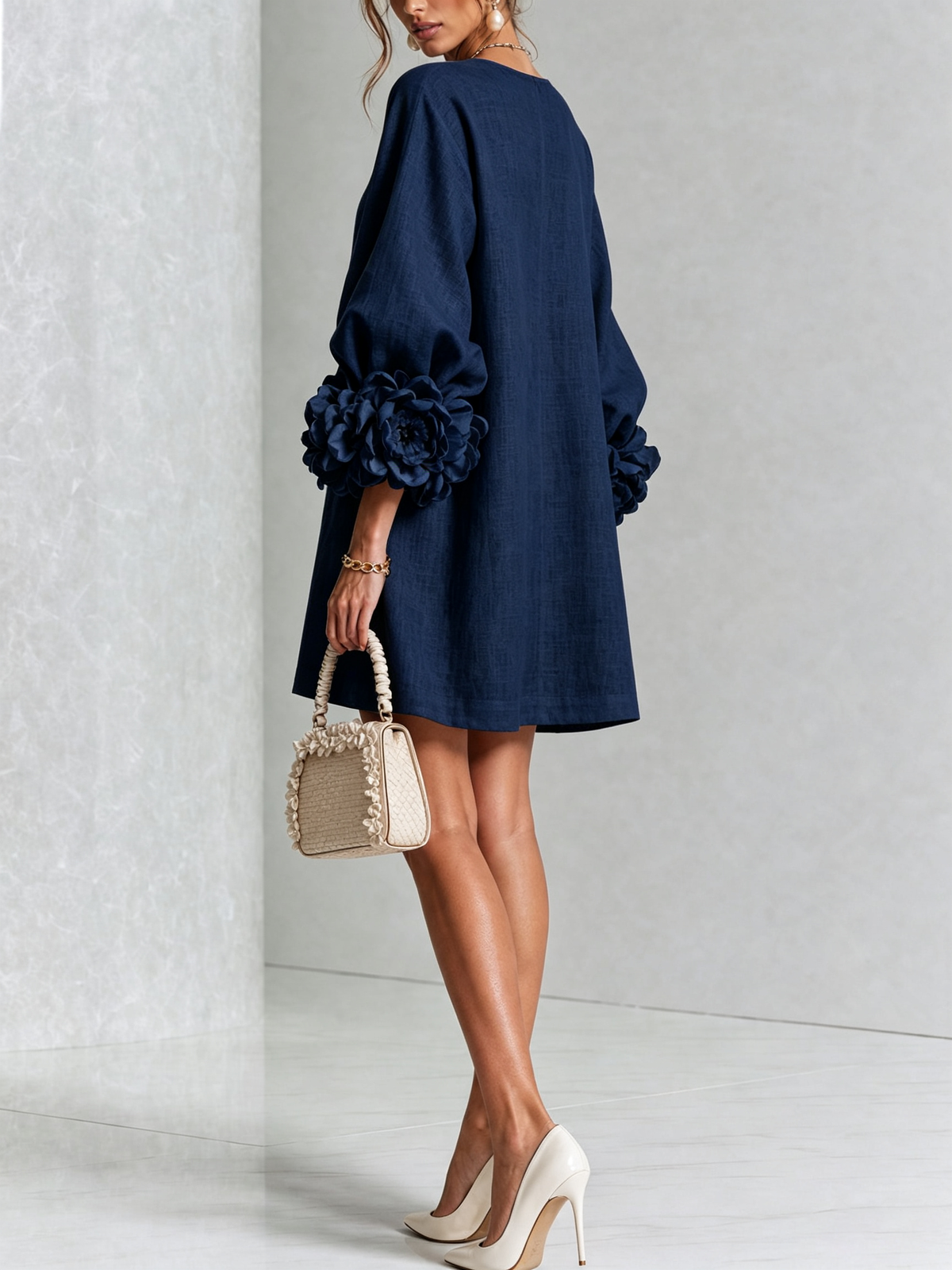Navy button-down mini dress with rosette puff sleeves and front button placket