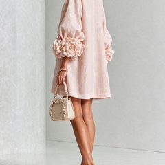 Blush button-down mini dress with long sleeves and rosette-style cuff details