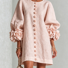 Blush pink button-down mini dress with vertical button placket and rosette puff sleeves