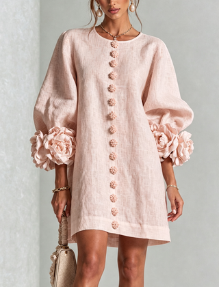 Blush pink button-down mini dress with vertical button placket and rosette puff sleeves