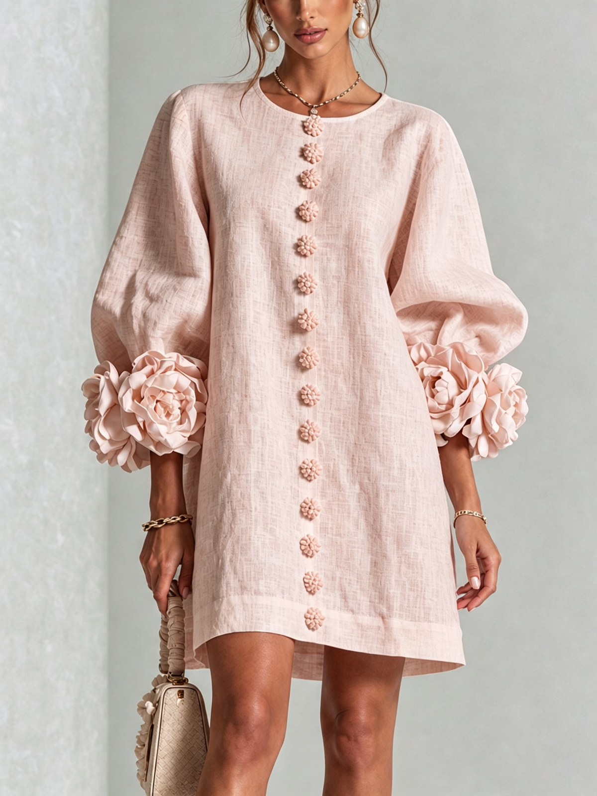 Blush pink button-down mini dress with vertical button placket and rosette puff sleeves