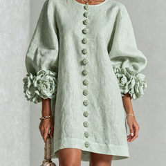 Sage green button-down mini dress with vertical button placket and ruffled sleeve flowers