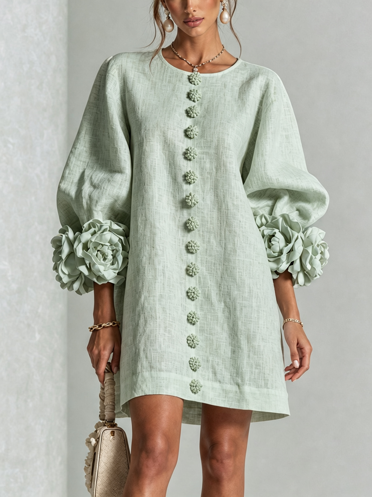 Sage green button-down mini dress with vertical button placket and ruffled sleeve flowers