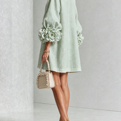 Sage green button-down mini dress, back/side view, with vertical button placket
