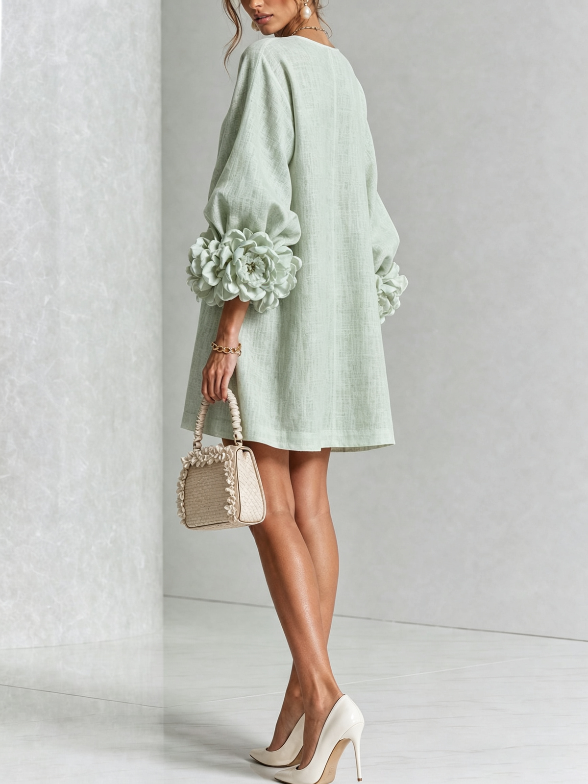 Sage green button-down mini dress, back/side view, with vertical button placket